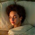 Person sleeping peacefully in a comfortable bed